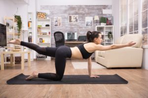 Young woman in legging doing balance yoga pose